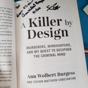 the title page of "A Killer by Design" signed to Gus and Oliver from Dr. Ann Burgess and Steven Constantine