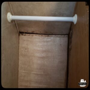 inside one of the closets of the mobile command unit trailer showing warped walls, water damage, and mold.