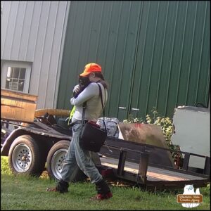 trailcam footage of black cat Gus being carried by human Amber on patrol/adventure on a hot afternoon.